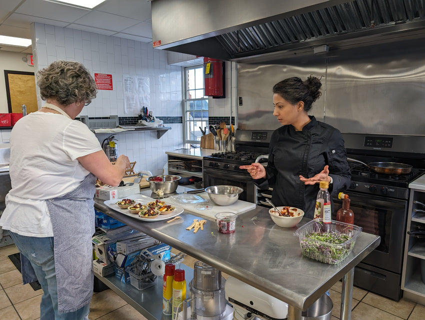 Chef Renu preparing appetizers for guests at Kitchen Table in Maplewood, NJ