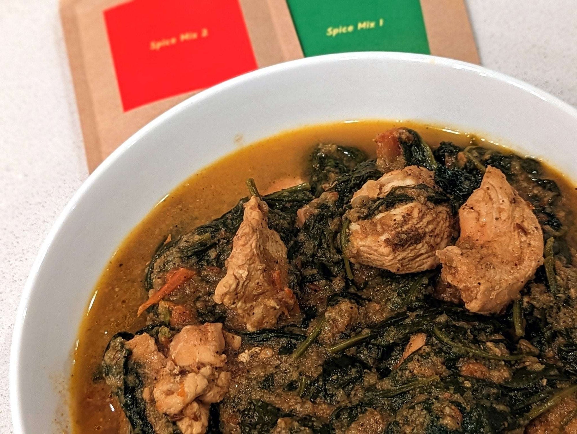 a bowl of soup and meat in a bowl