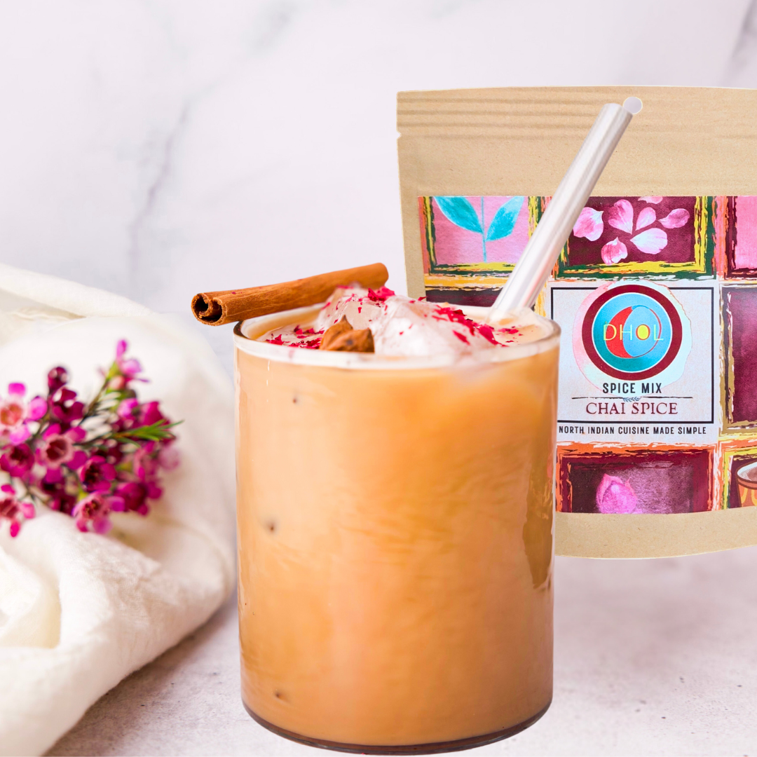 refreshing iced chai latte made with dhol chai spice, garnished with a cinnamon and rose petals